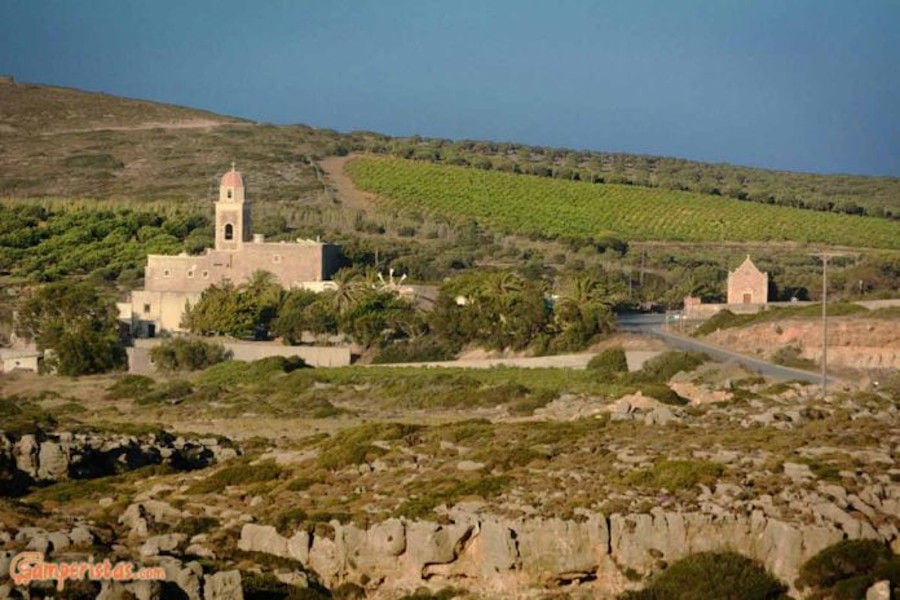 'Ktima Toplou' monastery with her tower surrounded by vineyards, trees and sea